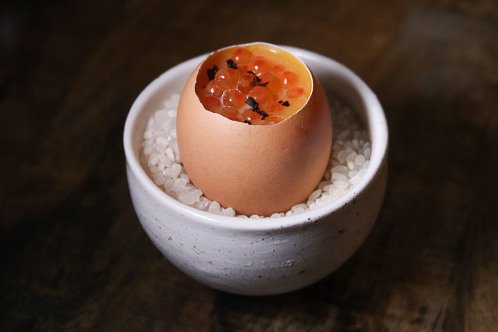 An inventive free-range hen egg dish with smoked eel, foie gras, and Yarra Valley salmon roe